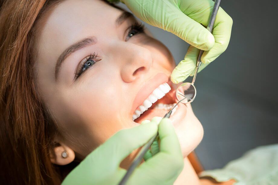 dentist examining woman's teeth