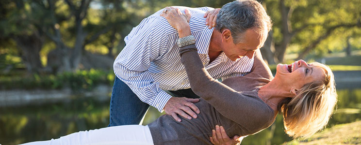 Happy Senior Couple Dancing in the Park