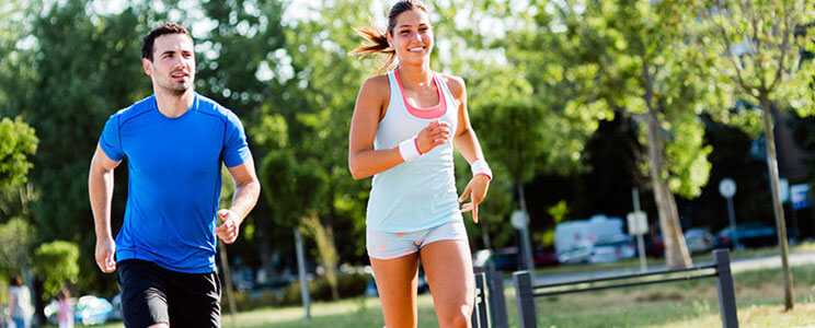 Athletic Man and Woman Jogging on Public Track