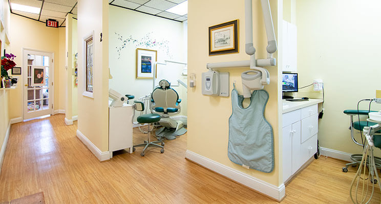 Long Hallway Featuring Several Dental Spaces for Patients